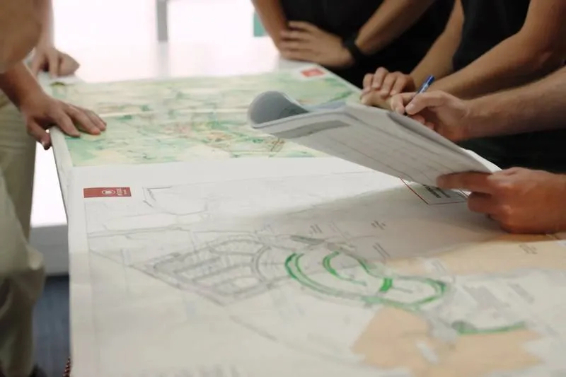 Engineers reviewing large-format site plans during a design review